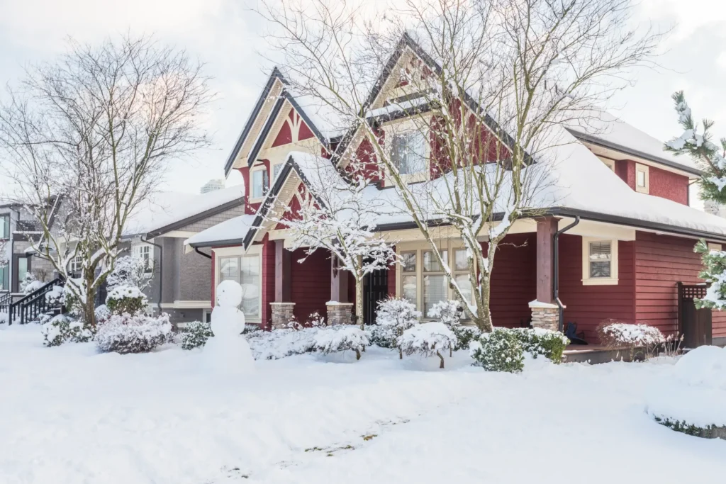 House in winter receiving heater maintenance for optimal warmth and efficiency.